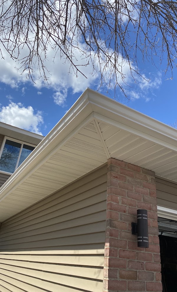 Almond seamless gutter on a brick and siding home